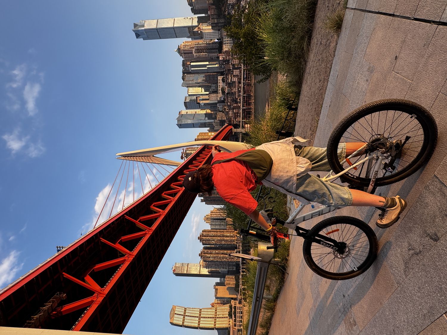 Cyclist beneath Dongshuimen Bridge at sunset