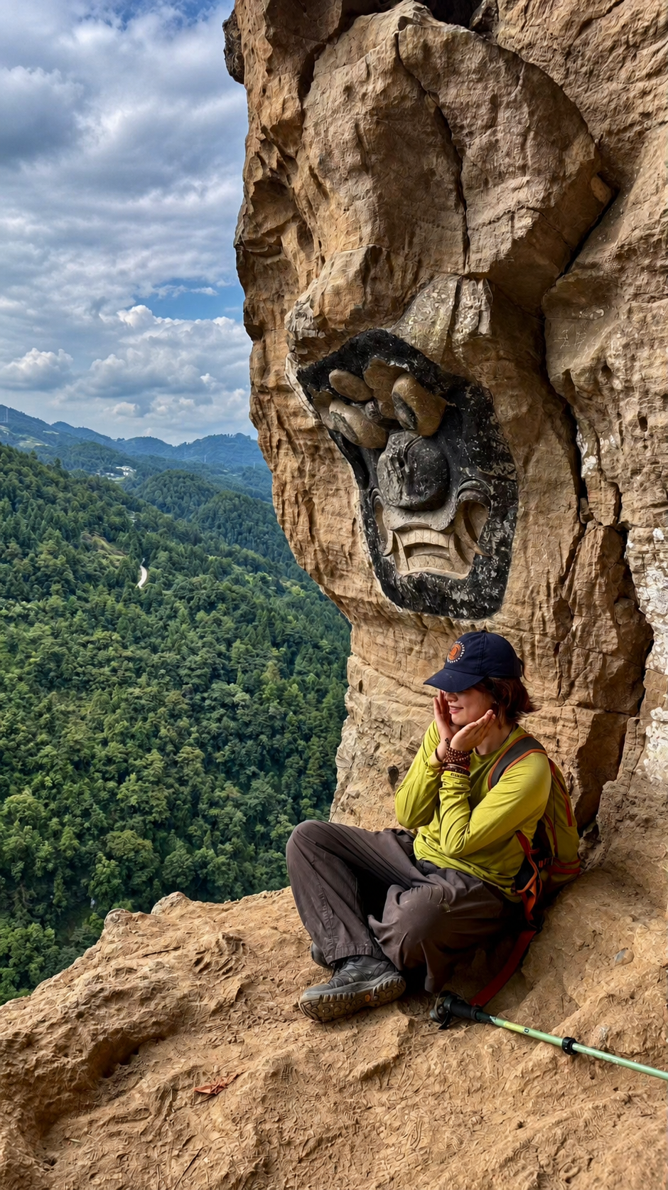 Hiker beside a cliff carving above the forest